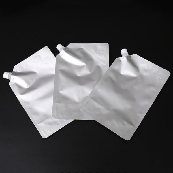 Spouted stand up barrier pouches